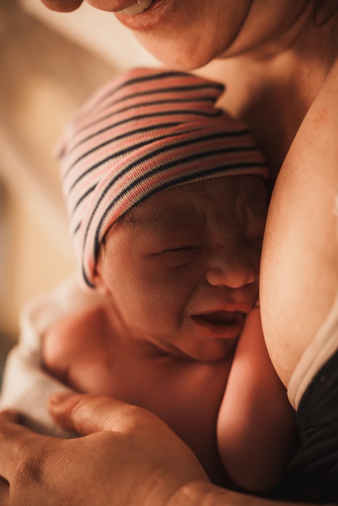 Newborn baby close to her mother after the birth, birth at the AMC Amsterdam with doula support