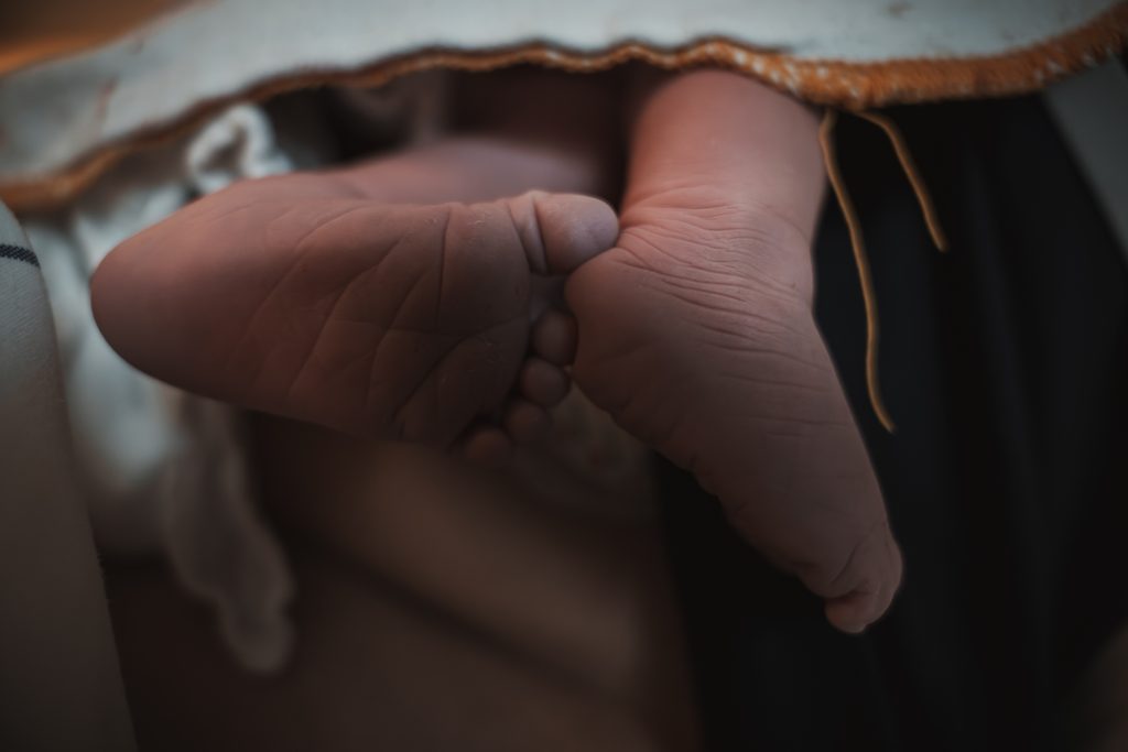 Close-up of newborn feet in the delivery room, birth at the AMC Amsterdam with doula support
