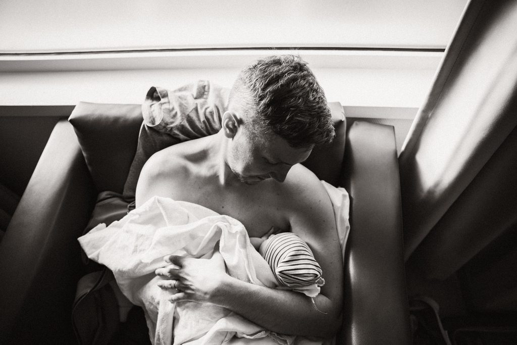 Mother resting with her newborn on her chest after an induction, black and white, birth at the AMC Amsterdam with doula support