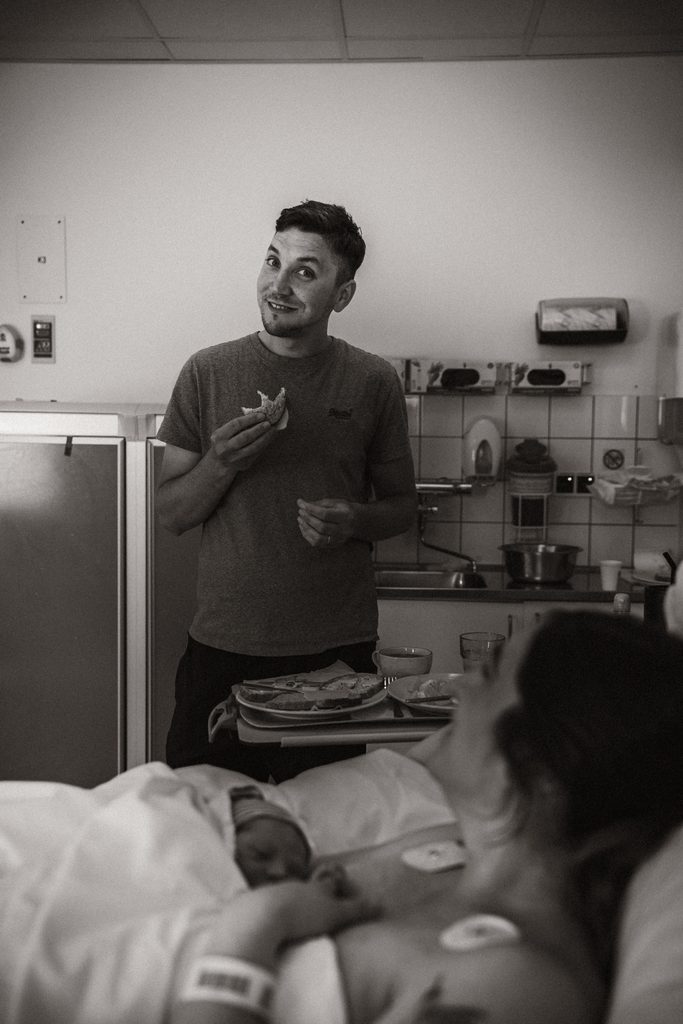 Father waiting by the hospital bed during an induced labour, black and white, birth at the AMC Amsterdam with doula support